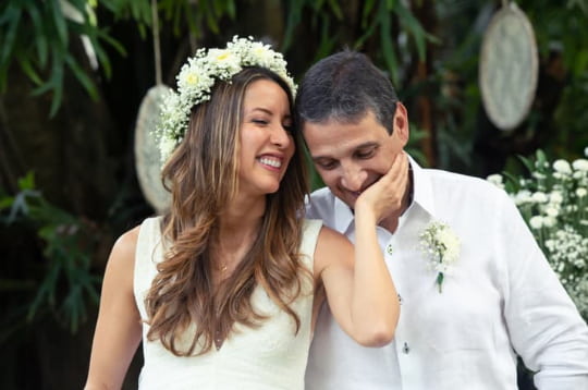 a bride and groom smile on their wedding day